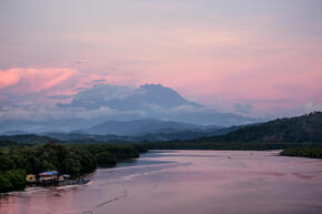 A view of Mount Kinabalu over Menkabong river, Sabah, Malaysia.