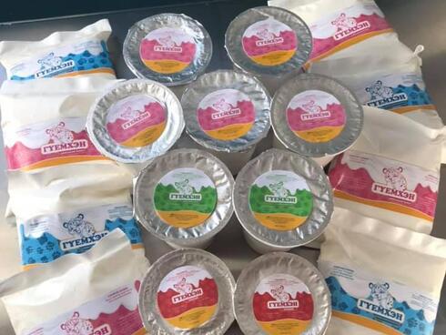 A pile of Mongolian yak dairy products in plastic pink and blue packaging