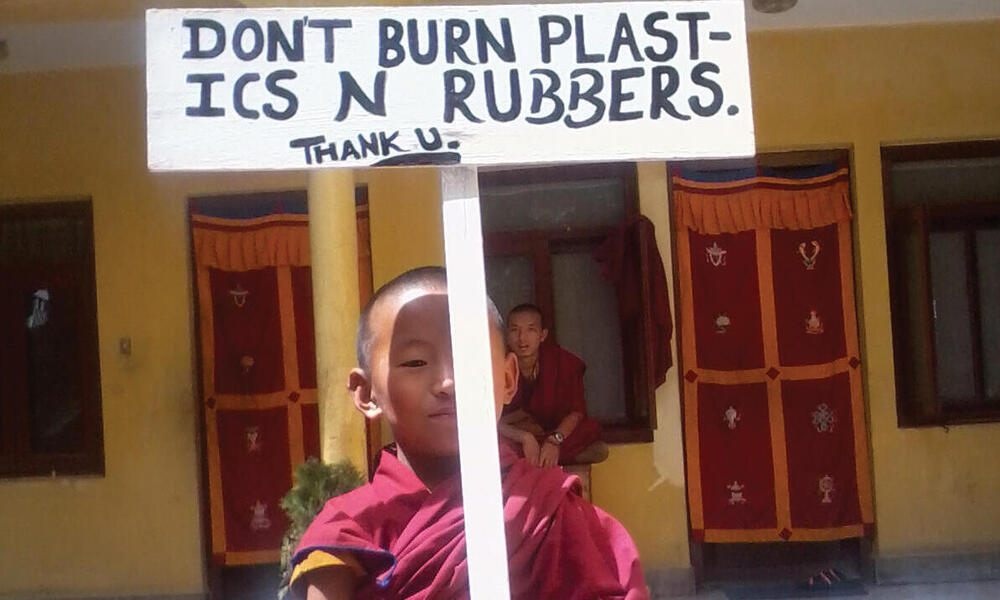 monk holding sign