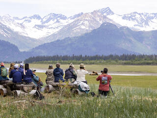 Travelers taking a photo in Alaska on Natural Habitat Adventures' Bear Camp trip