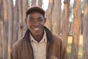 Nelson Sabata, a guide at Camp Chobe, outside his home in Katounyana.