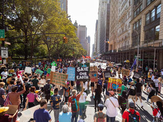 Marchers hold signs at New York City Climate March