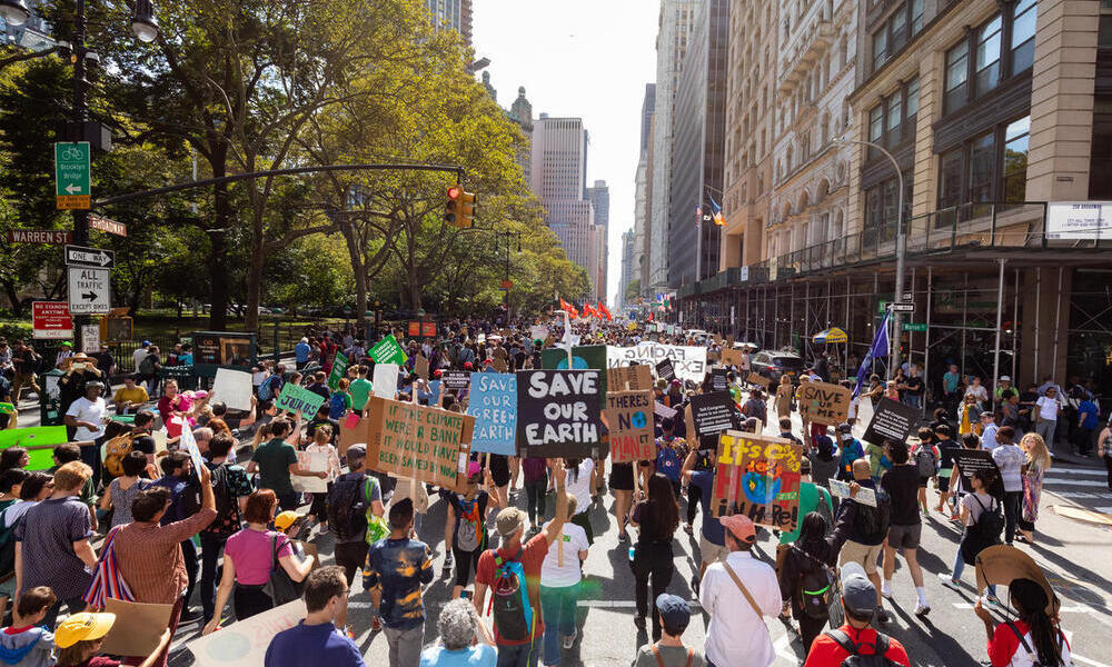 Marchers hold signs at New York City Climate March