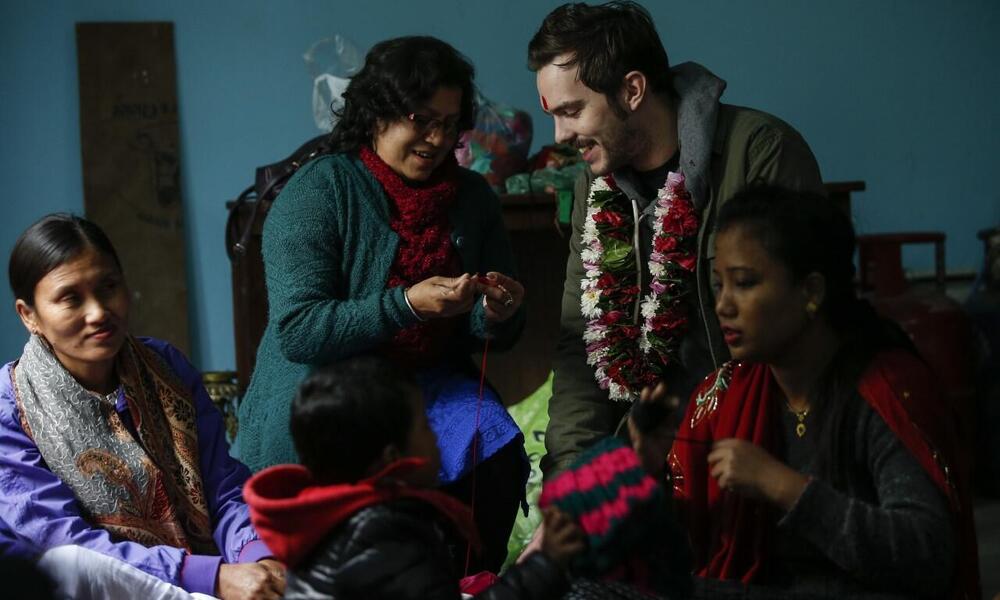 Nicholas Hoult learns to knit with Amaltari community members in Nepal.