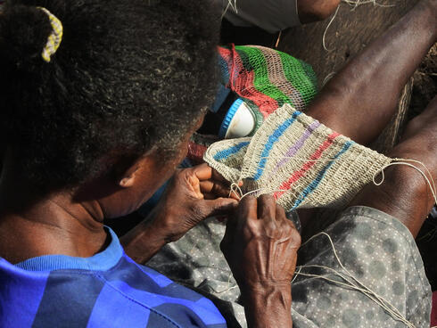 Woman hand weaving bag