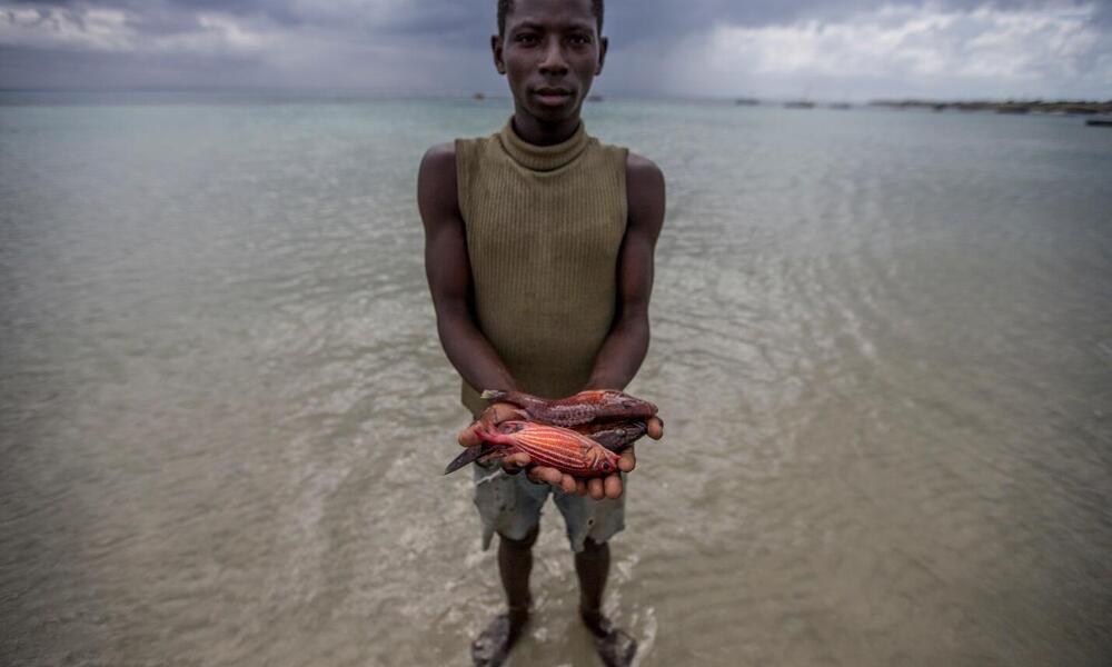 A Nuarro fisher shows off his catch