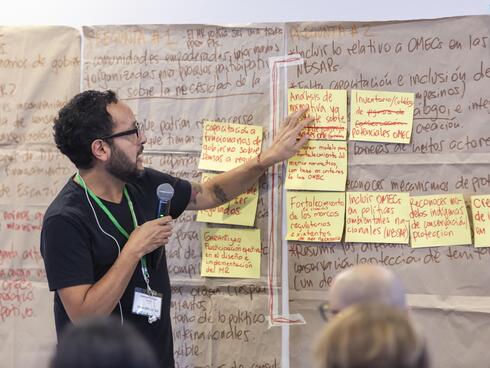 Leader of workshop poings to notes addressing colleagues