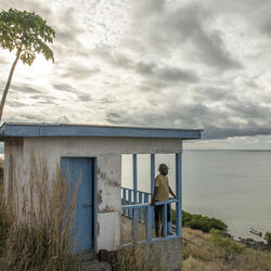 Henry R. Kolinirai, a turtle monitor representative of the Nakawaga village, overlooks the bay from the WWF-funded guard house on northern Mali Island. 