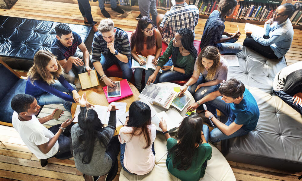 Group of students sitting on floor in circle