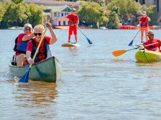 Paddlers using boards and boats on the water