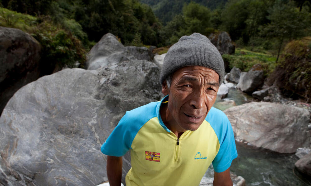 Pasang Themba Sherpa in front of water