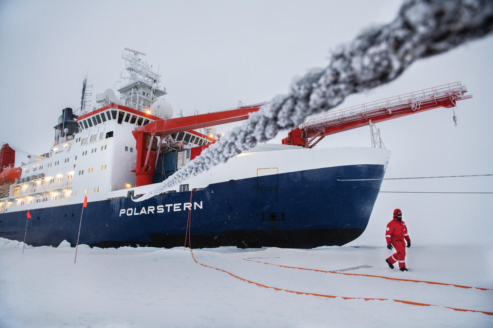 Ship in ice with crewperson walking outside