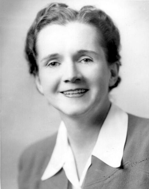 Rachel Carson photographed in black and white and smiling at the camera