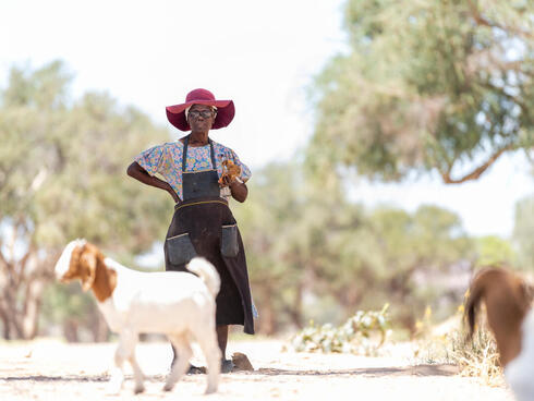 Rebecca Adams with a pair of her goats outside De Riet village, Namibia