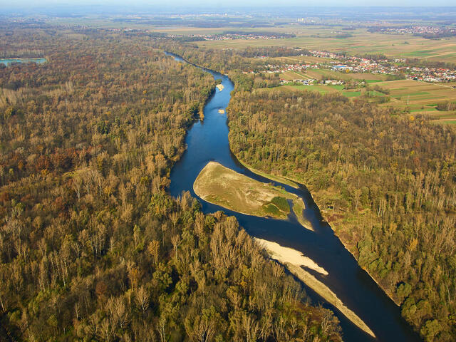 Aerial view of the River Mura with a town in the distance