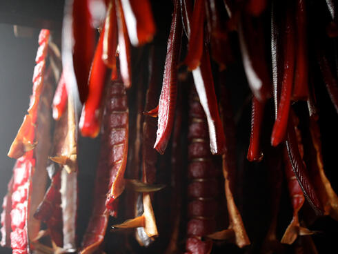 Closeup of salmon hanging in a smokehouse