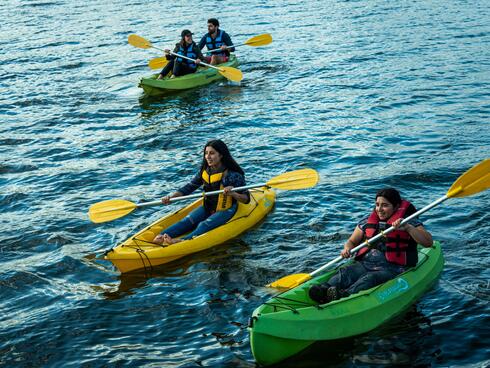 Sandra Antipani and Yasmin Uribe Rivera lead a group of ecotourists on kayaks