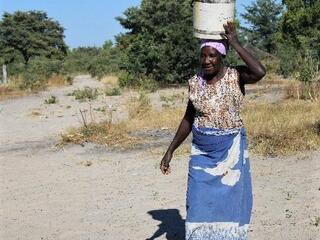 Sepiso Mulonda of the Kapau community carrying bucket of water on her head