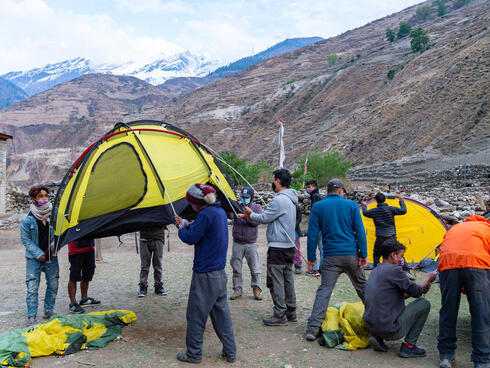 Snow leopard team sets up camp at the base of a mountain
