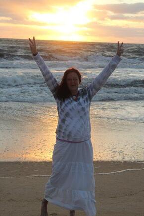 Shawn Walker stands in front of the ocean