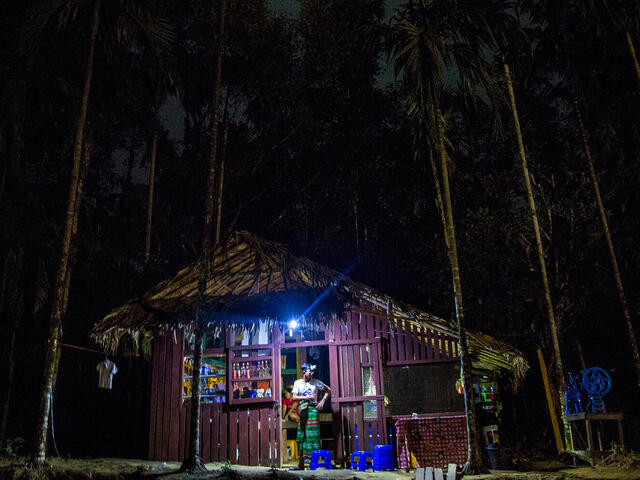 Illuminated village shop in dark landscape