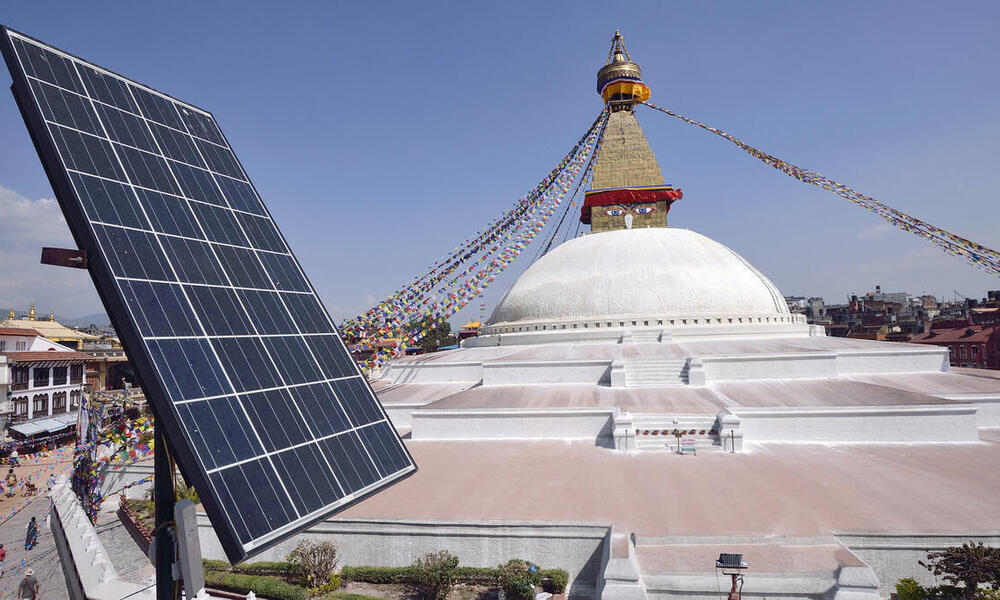 Solar panel on a roof top over looking a Buddhist shrine, Bodhnath Stupa in Kathmandu, Nepal