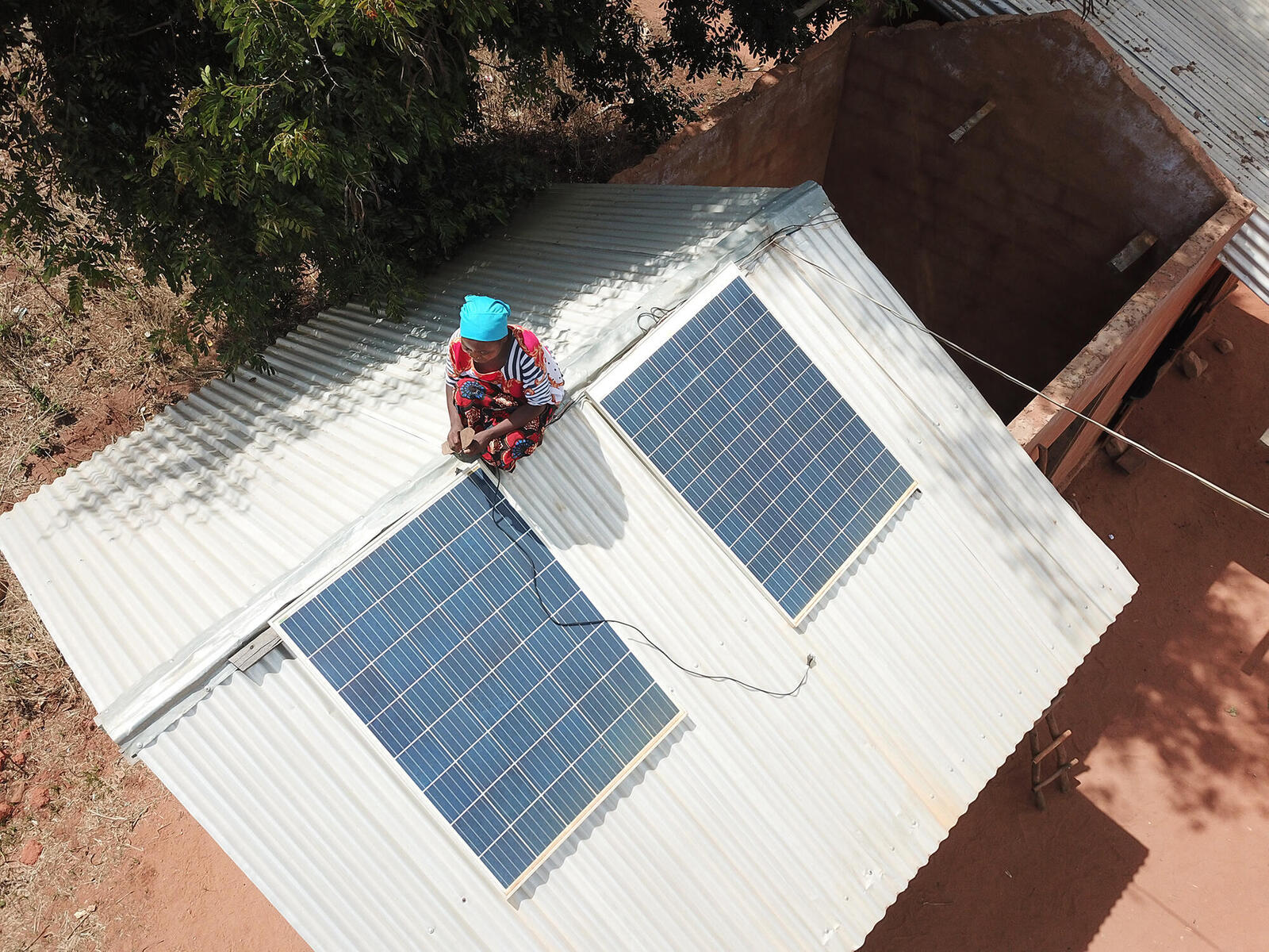 Woman on roof adjusting solar panels