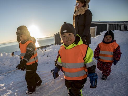 Young children walking to school in Ittoqqortoormiit, Greenland. 
