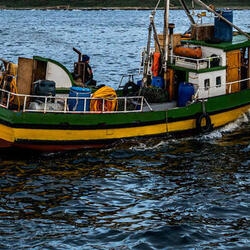 An artisanal fishing boat navigates off the coast of Guafo Island