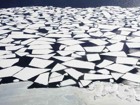Aerial view of melting ice in the Bering Strait, Wales, Alaska, United States.