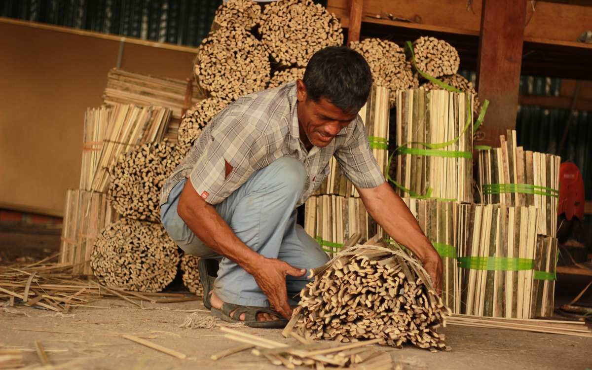 Worker organizing wood