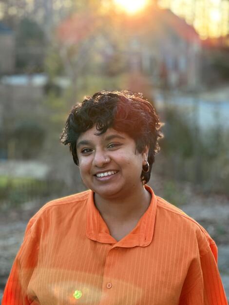 Portrait of Tarunika Anand in an orange shirt