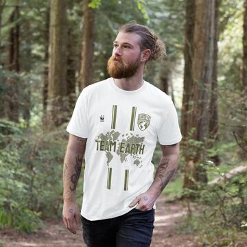 man wearing a white Team Earth t-shirt walking in a forest