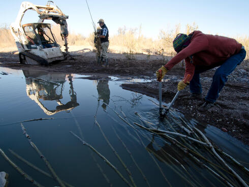 The auger digs holes in Terlingua Creek