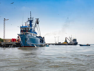A tuna fishing boat docked in Ecuador on a sunny day