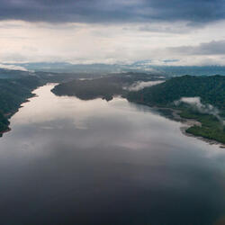 river heading to the horizon with forest on both sides