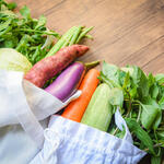 Vegetables in a tote bag on a counter