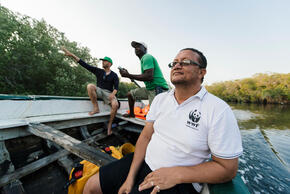 Three WWF Mozambique staff in the mangroves on a boat patrol near Palma, Mozambique, Africa.
