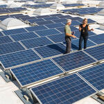 WWF's Marty Spitzer and Walmart's Katherine Neebe discuss sustainability issues on a Walmart roof, with solar panels.