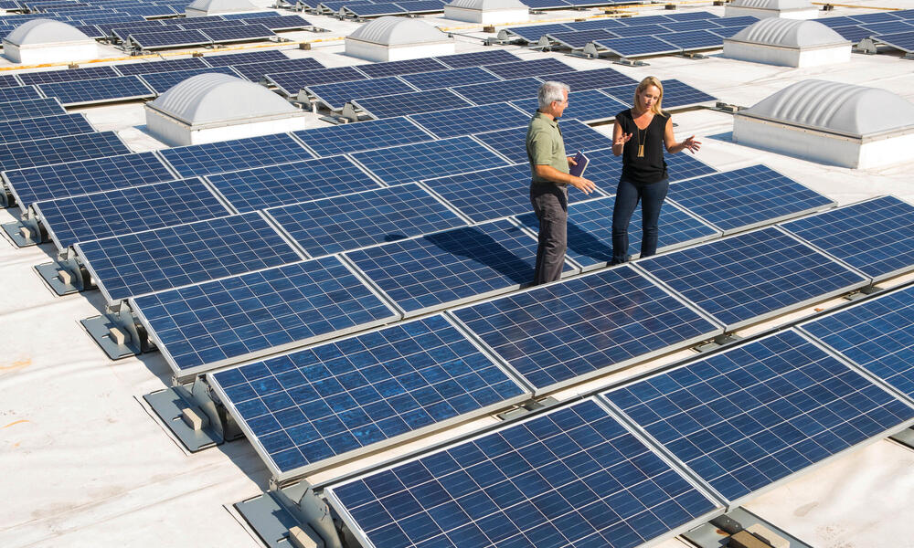 WWF's Marty Spitzer and Walmart's Katherine Neebe discuss sustainability issues on a Walmart roof, with solar panels.