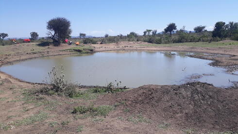 A large pool of water meant for people and livestock