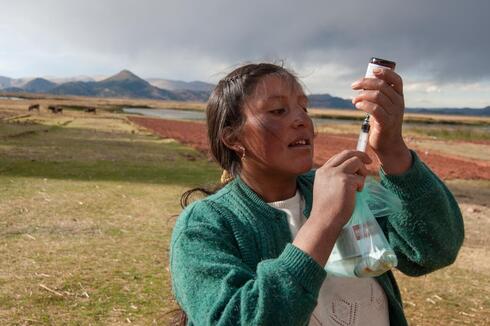 Woman filling syringe with medicine