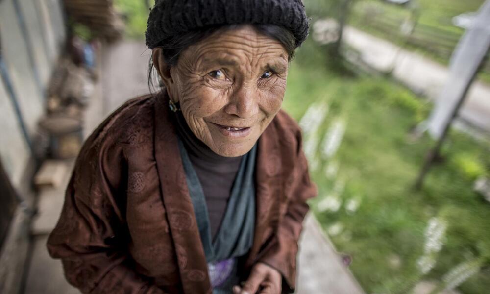 Woman outside her home in Bhutan
