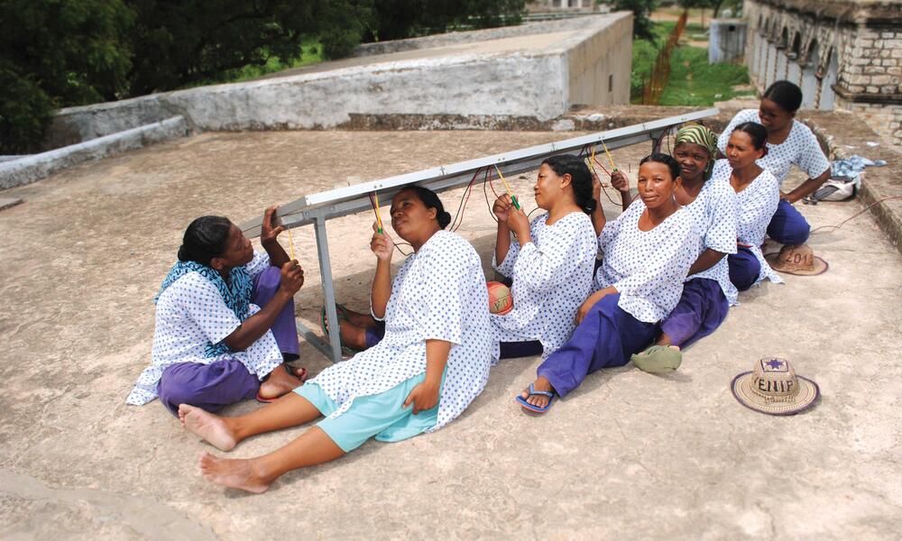 women work on solar