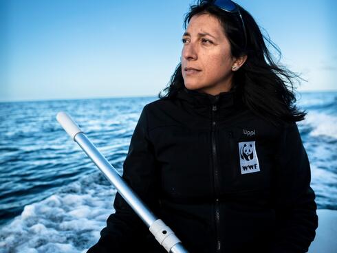 WWF's Yacqueline Montecinos monitors whale activity from a dinghy in the waters near Guafo Island