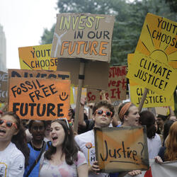 People carry a banners and signs to the start of the People's Climate March in New York City