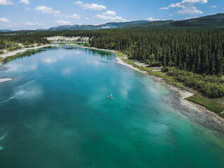 Aerial view of Yukon River with trees and mountaintop