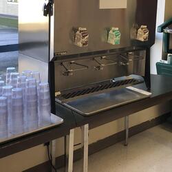 A bulk milk dispenser in a school cafeteria