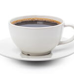 A cup of black coffee in a white cup and saucer