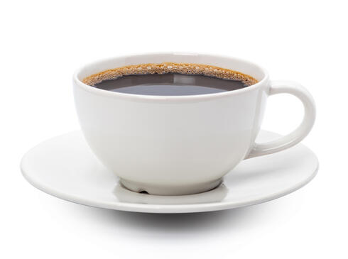 A cup of black coffee in a white cup and saucer
